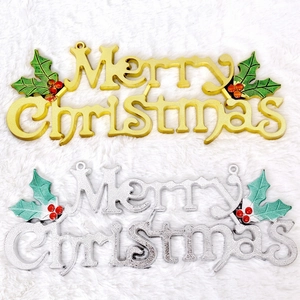 Golden and silver Merry Christmas door signs decorated with holly on white plush background