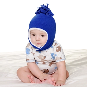 Detail of warm royal blue fleece baby hat with soft white faux sherpa lining and ear flaps
