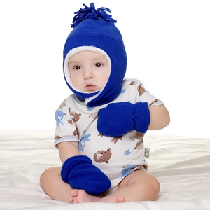Close-up of baby winter set featuring navy fleece earflap hat and matching mittens
