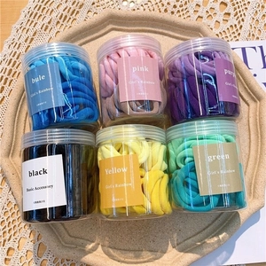 Set of 50 seamless high-elastic hair ties in six pastel colors stored in transparent jars