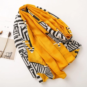 Detailed macro view of high-quality linen scarf with yellow and black geometric patterns