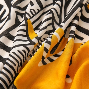 Macro shot of geometric print scarf showing detailed texture and modern abstract design