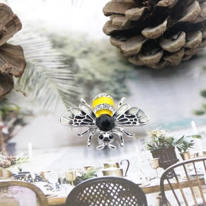 Detailed macro view of the bee brooch with crystal wings and yellow enamel abdomen