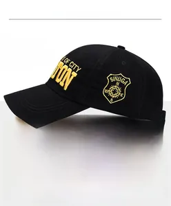Detail of black cotton baseball cap showing 3D yellow embroidery and adjustable metal buckle