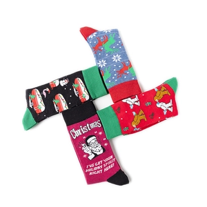 Macro detail of four assorted festive Christmas cotton crew socks with holiday patterns