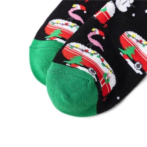 Detailed view of Christmas socks featuring flamingo and camper patterns with green toes