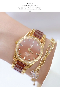 Detail of luxury rose gold watch with brown ceramic inlay and sparkling rhinestone bezel