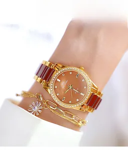 Detail of elegant ladies' watch set with brown ceramic links and floral gold bracelet