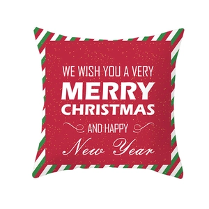 Detail of red Christmas pillowcase with holiday text and striped edge decoration