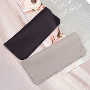 Close-up of litchi texture on black and grey PU leather sunglasses pouches