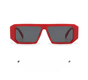 Detailed front view of modern red square sunglasses with dark grey tinted lenses