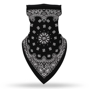 Detail of ear-loop face mask showing white paisley print on black stretch fabric