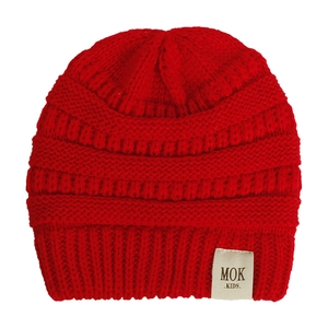Detail of red cable-knit baby beanie featuring a stitched MOK KIDS label on white background