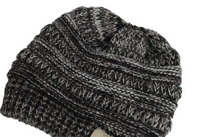 Close-up detail of soft coffee and white chunky knit texture on warm baby winter beanie
