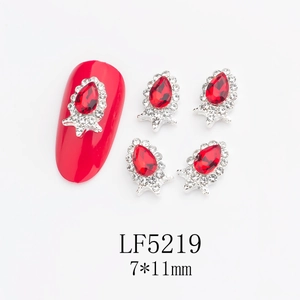 Macro shot of 7x11mm red teardrop nail crystal with silver alloy and clear rhinestones