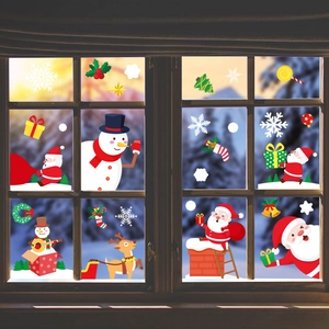 Christmas window stickers set with Santa, reindeer and snowman on a snowy glass window