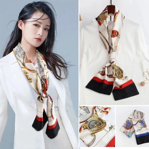 Detail of nautical print twilly scarf with anchors and chain patterns in red and blue