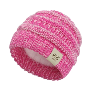 Detail of pink knitted baby beanie with warm white fleece lining and MOK label