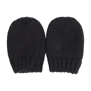 Detail of black knitted baby mittens with ribbed elastic cuffs on white background