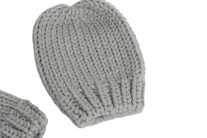 Detail of light grey chunky knit baby hat showing thick ribbed texture and soft weave