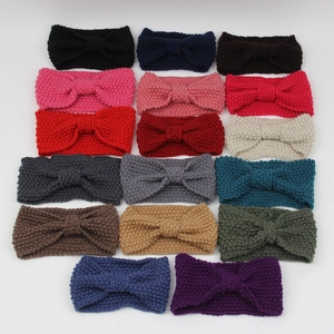 Flat lay display of 17 colorful knitted bow headbands in various vibrant shades