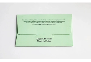 Macro view of light green paper packaging for silver polishing cloth measuring 10x7cm