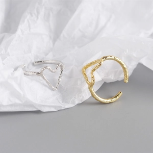 Detailed view of silver and gold heart-shaped rings with unique foil texture