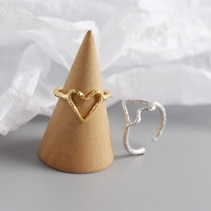 Macro view of gold and silver heart rings with unique hammered foil texture details