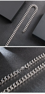 Detailed view of silver stainless steel Cuban link necklace with polished surface