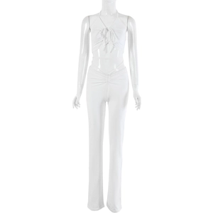 Detail of white halter neck top with drawstring and high waist straight leg trousers
