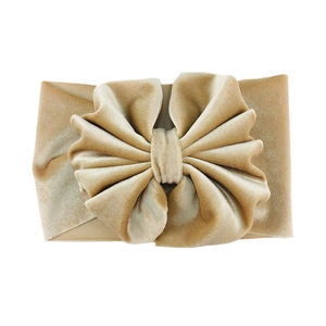 Detail of champagne velvet oversized bow headband with soft elastic texture for infants