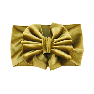 Macro view of mustard yellow velvet oversized bow headband with soft textured finish