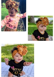 Detail of baby girl wearing a large mustard yellow velvet bow headband in outdoor setting