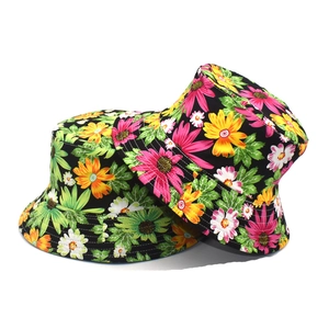 Detailed view of reinforced stitching and tropical floral patterns on cotton bucket hats