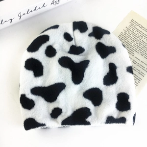 Unisex cow print knitted beanie in black and white winter warm casual style