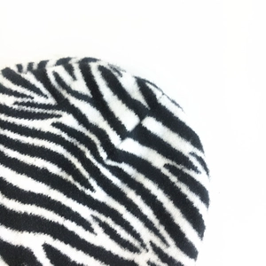 Close-up of zebra pattern knitted fabric texture with soft black and white fibers