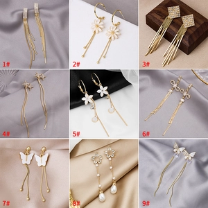 Collage of nine tassel earrings with pearls, crystals, butterflies, and flower patterns