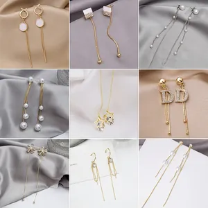Detailed grid of silver and gold tassel earrings with pearls and crystal accents