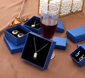 Chic peacock blue jewelry gift boxes featuring golden Roman numeral necklace and earrings