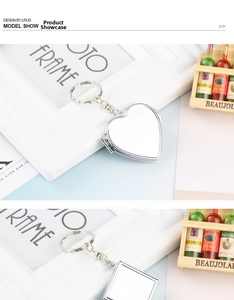 Macro view of silver metal keychain vanity mirrors in heart and square shapes