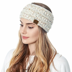 Detail of cream cable knit headband with warm fleece lining and brown MOK leather patch