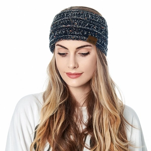 Model wearing dark blue knitted winter headband with soft fleece lining and MOK leather tag