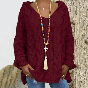Macro shot of burgundy cable knit hoodie sweater showing thick knit texture and V-neckline