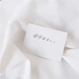 Macro shot of six graduated clear cubic zirconia stud earrings on S999 silver bases