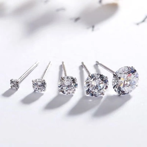 Detailed macro view of S999 sterling silver stud earrings with graduated zircon sizes