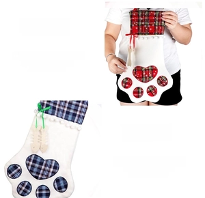 Detail view of plaid pet paw Christmas stockings with bone charms and soft pom-poms