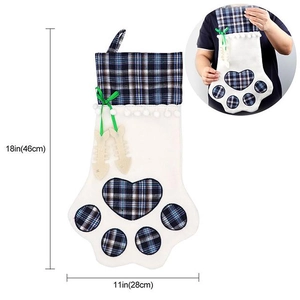 Dog paw Christmas stocking showing 18x11 inch dimensions and green ribbon detail