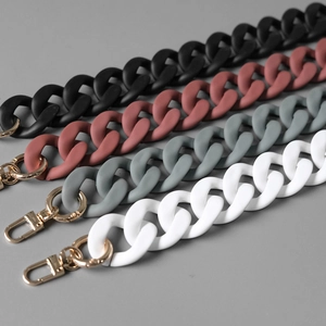Macro detail of matte acrylic chunky bag chains with gold lobster clasps in four colors