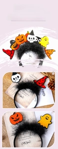 Detail of Halloween headband with black feathers, pumpkin, skull and ghost decorations