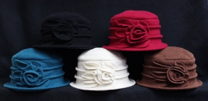 Detailed pile of elegant wool felt cloche hats featuring decorative 3D flower accents